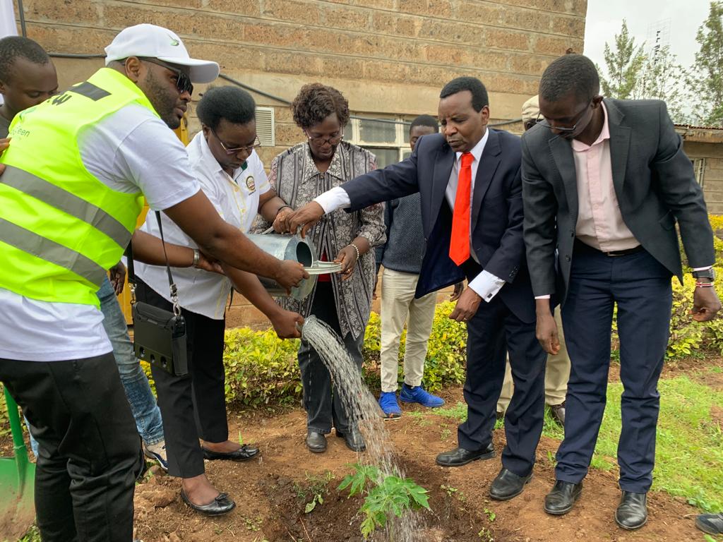 Kigame with former MP Linah Chebii Kilimo, Executive Director of Kenya Society For the Blind Samson Waweru (with reflector jacket) among others after planting a tree.