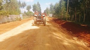 A farmer transporting goods on a tractor along the completed Randich road in Simat Kapseret ward.