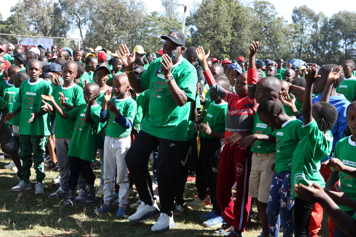 Governor Bii interacts with children during Eldoret Mater Heart Run