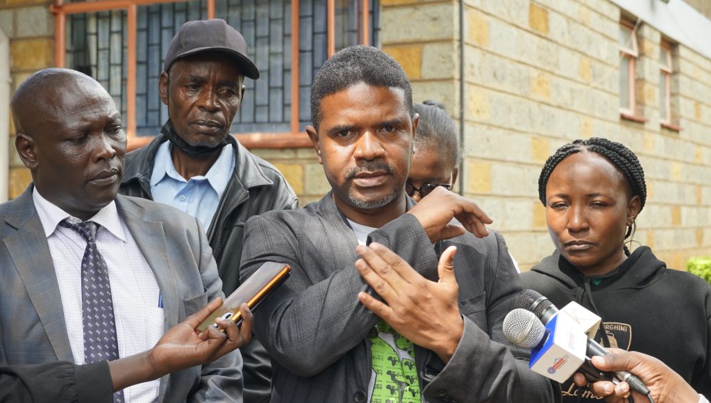 HAKI Africa’s Senior Programmes Officer, Hussein Khalid (centre) with Eldoret based human rights activist Kimutai Kirui with the family of the deceased addressing the [ress at MTRH on June 6, 2023.