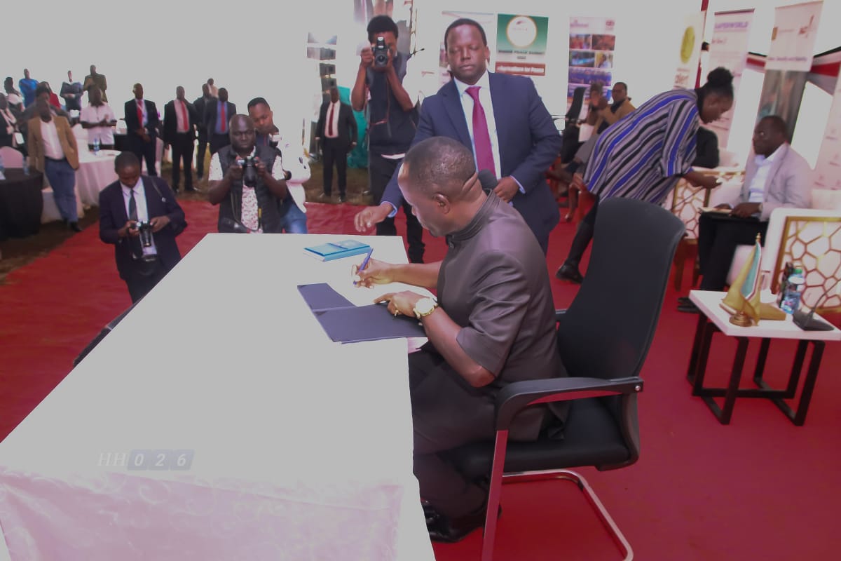 Natembeya signing the resolution at the summit.