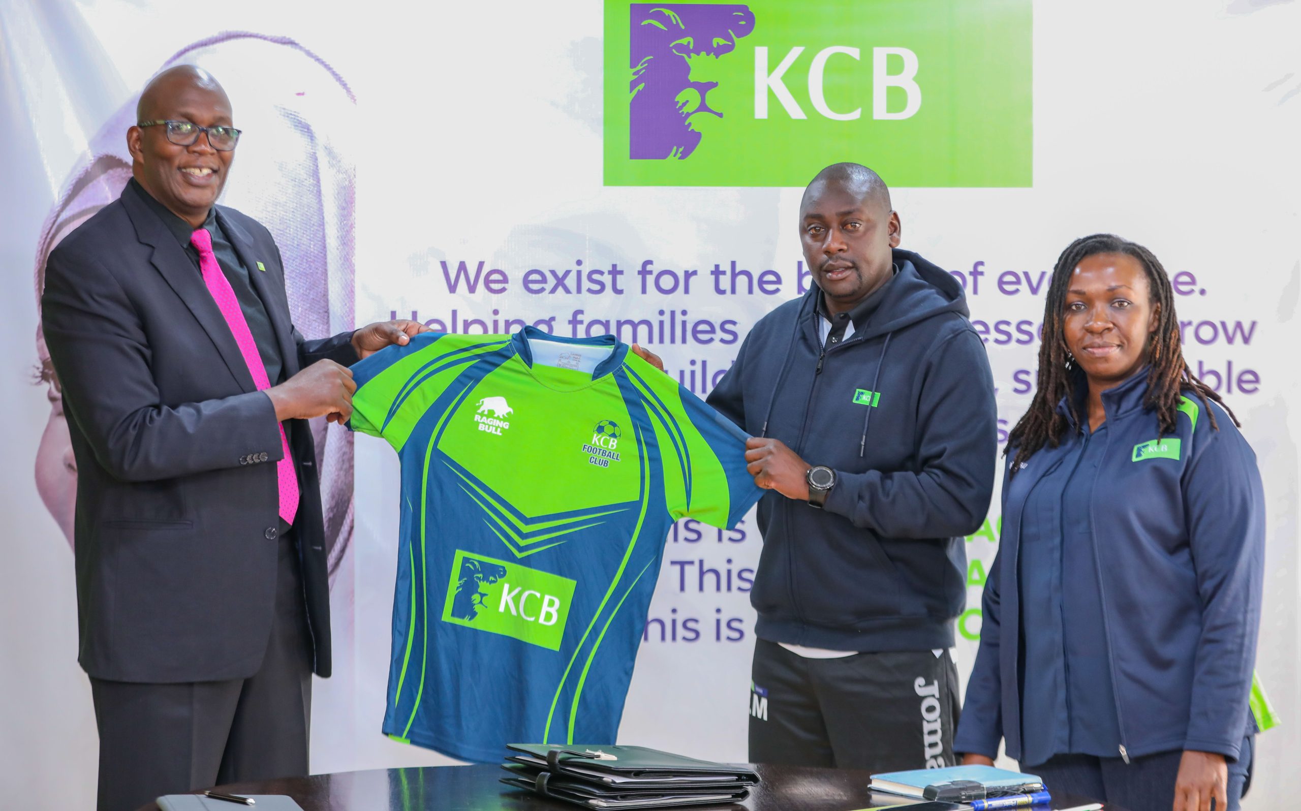 From left KCB football patron Azu Ogola, hands over a KCB football Jersey to Bernard Mwalala the new KCB FC coach. Looking on is the KCB Head of Integrated Marketing Nkatha Mutungi during the unveiling of the new head coach at Kencom House on July 14, 2023..