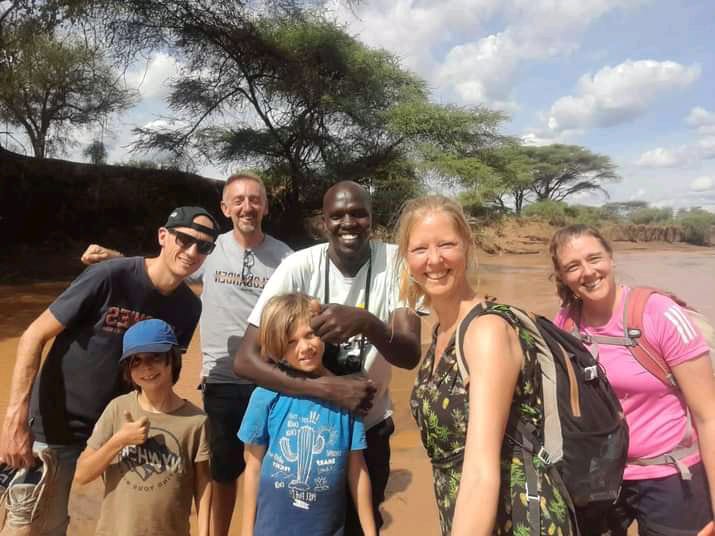 Kibet with some of the foreign tourists at the Rimoi National Reserve.