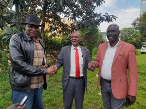 From left, Sabaot community Elders Francis Chemwor, Peter Chemasuet and Willy Ndiwa holding hands after a presser in Kitale. Photo/Kipkorir Tarus