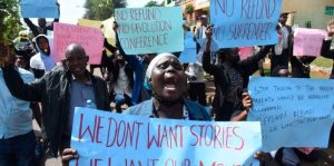 Parents and their children who are affected by the Finland and Canada students airlift programme through Uasin Gishu County government, during a demonstration in Eldoret town, demanding a refund of their money