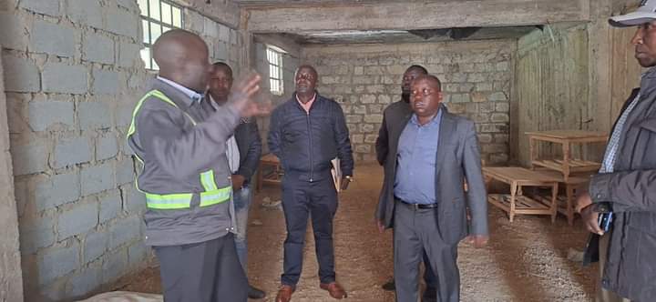 North Rift NCPB Regional manager Gilbert Rotich with County officials at the Chesoi cereal store.