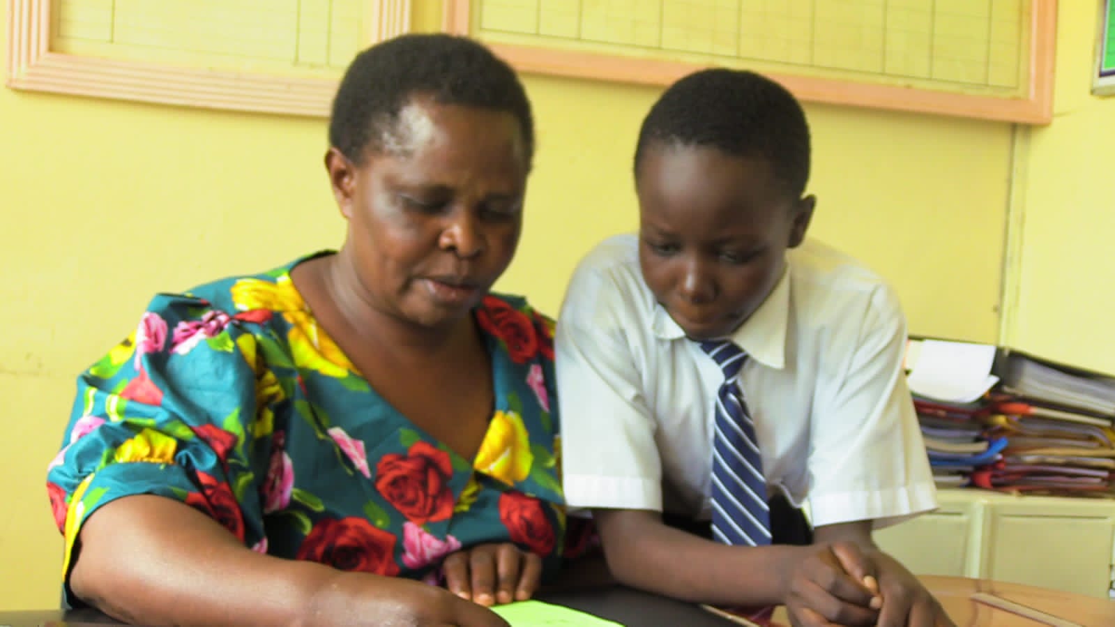 The student conversing with her teacher at Kapkoi Sisal Secondary School.