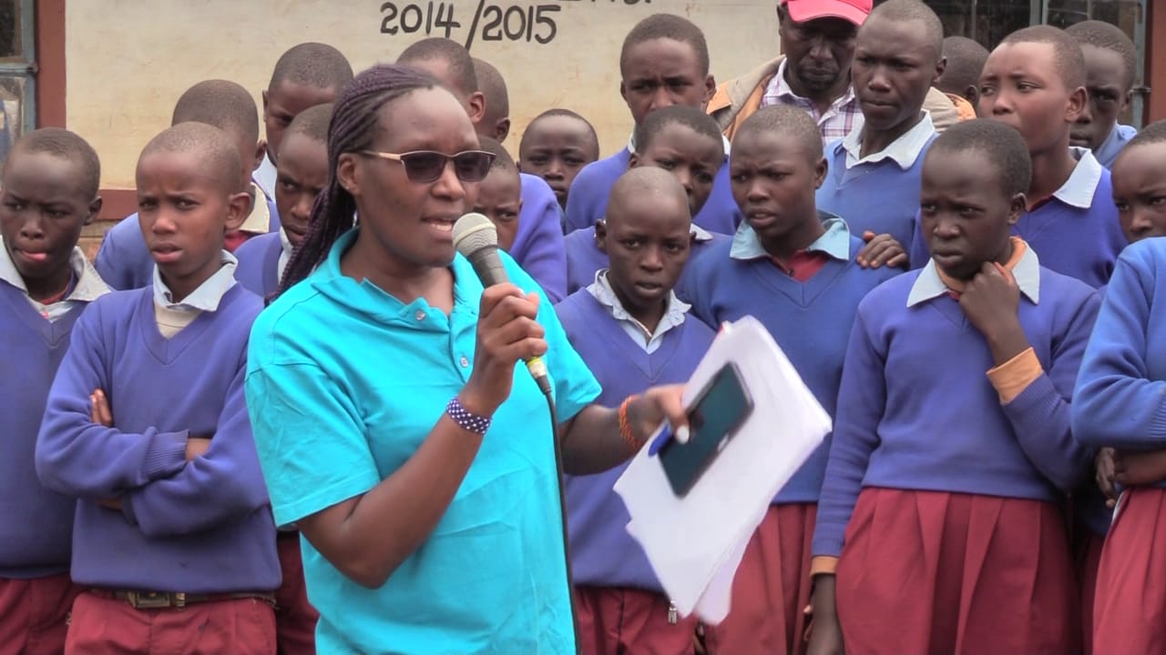 Jane Mwangi from Child Welfare Society speaks to some of the learners that will benefit from the donations.
