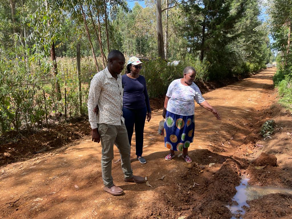 Evelyne Ng'etich(right), a resident of Kapkobil village shares information with the roads team during the inspection of the recently graded and graveled Kapkobil-Cheplaskei road in Ngeria Ward, Kapseret Sub County