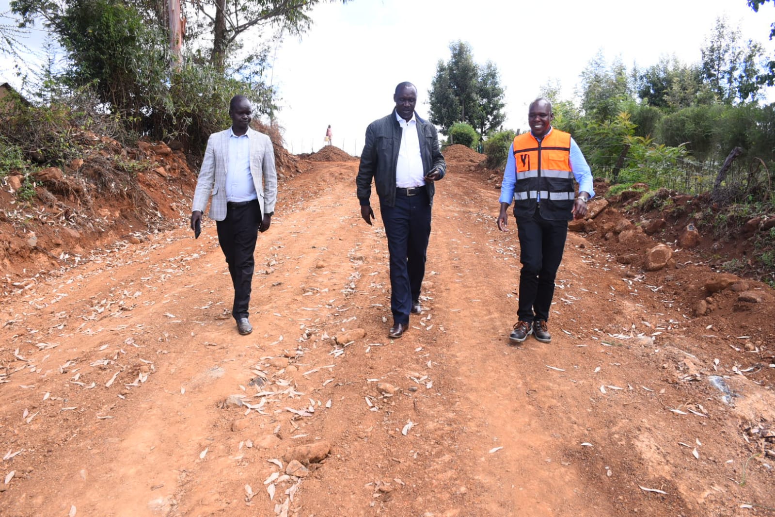 Roads Chief Officer Abraham Kiptalam with other county officials walk on one of the new roads.