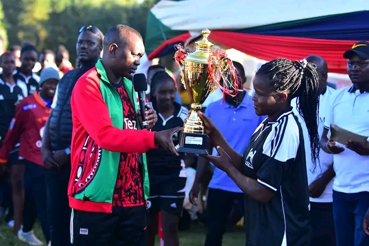 ESPODEC player being awarded the best goalkeeper trophy by MP Sudi.