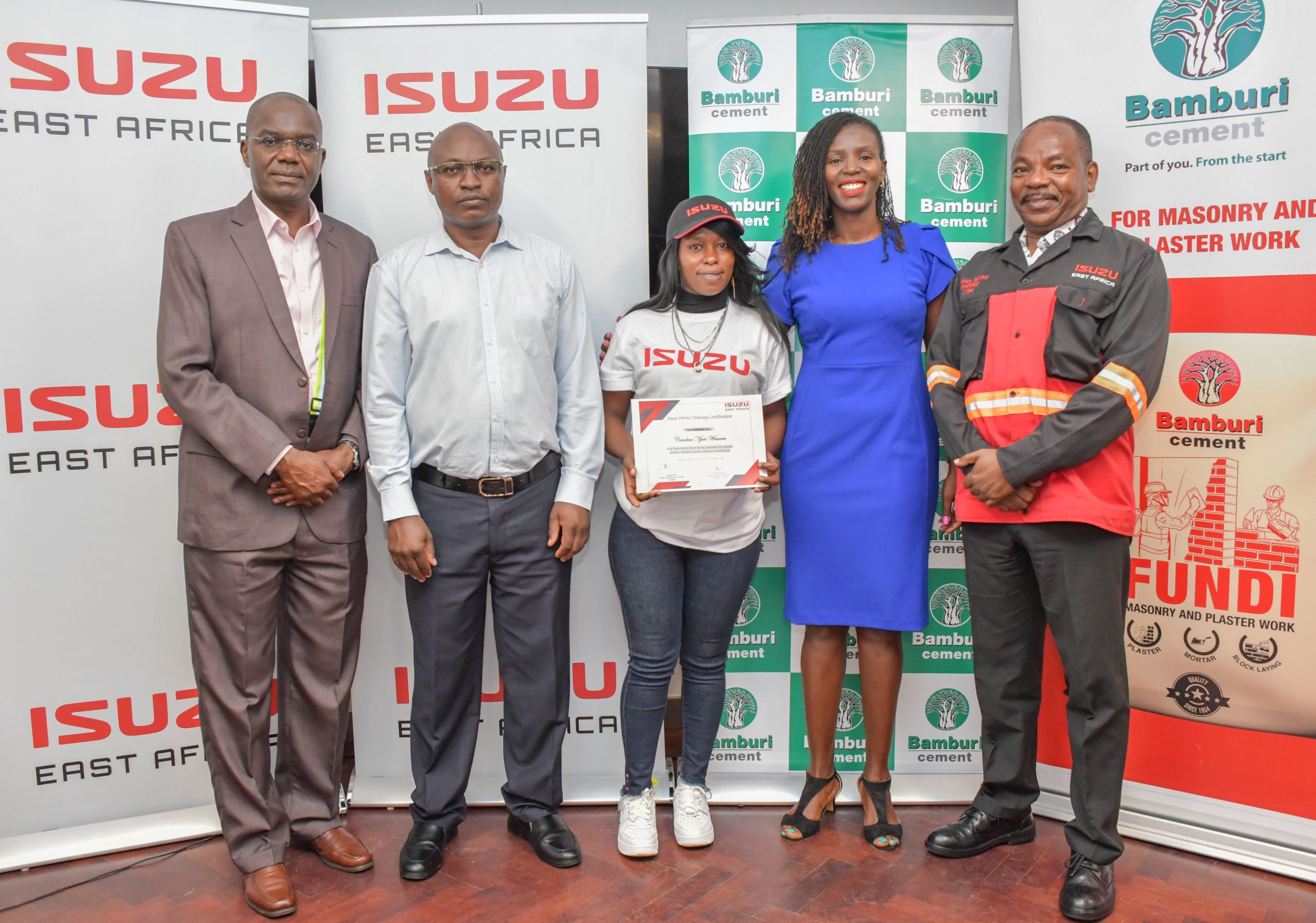 (L-R) Isuzu East Africa Human Resources and Corporate Sustainability Director,Fred Wasike, Isuzu EA General Manager Service Operations, Field Engineering and Training, Samuel Nyoro, Isuzu Drivers Academy graduand, Caroline Njeri, Bamburi Cement Plc Sustainability and Geocycle Director, Jane Wangari and Isuzu EA Service Operations and Training Manager, Daniel Gitau during Isuzu Drivers Academy graduation.