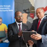 Equity Bank Kenya Managing Director Gerald Warui (right) and Equity Group General Manager, International Banking and Cross Border Payments Andrew Kabeke (left) discuss the instant PayPal withdrawal service available on Equity Mobile App and Equity Online. Photo/Equity Bank.