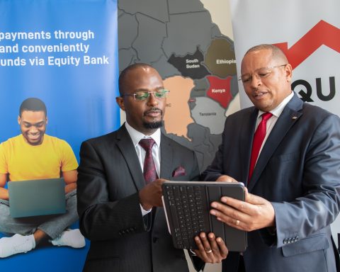Equity Bank Kenya Managing Director Gerald Warui (right) and Equity Group General Manager, International Banking and Cross Border Payments Andrew Kabeke (left) discuss the instant PayPal withdrawal service available on Equity Mobile App and Equity Online. Photo/Equity Bank.