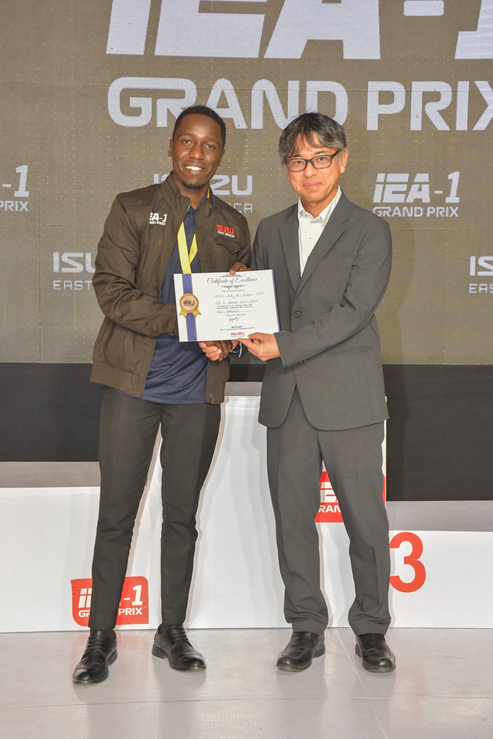 L-R) Isuzu Kirinyaga Road’s Parts Advisor, Chris Kahuthia is awarded by the Vice President, Aftersales Division Isuzu Motors International FZE, Masakazu Fukasawa for outstanding performance in the Overall 3s parts Advisor Category during the 2024 Isuzu East Africa Grand Prix on 17th April 2024.