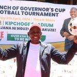 Uasin Gishu Governor Jonathan Bii holdings footballs in his hands
