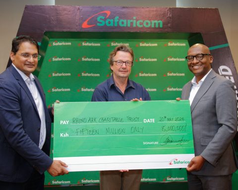 Safaricom Plc Chairman, Adil Khawaja Arshed (left) Rhino Ark Executive Director, Christian Lambrechts (center) and Safaricom plc Acting Chief Corporate Affairs Officer, Fred Waithaka holding a dummy cheque worth Ksh. 15,000,000 during the official cheque handover for the 2024 Rhino Charge sponsorship announcement.