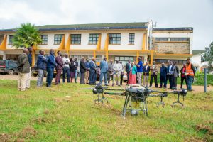 University of Eldoret and Customized Aviation Solutions Limited officials stand infront of a drone after signing of MOU