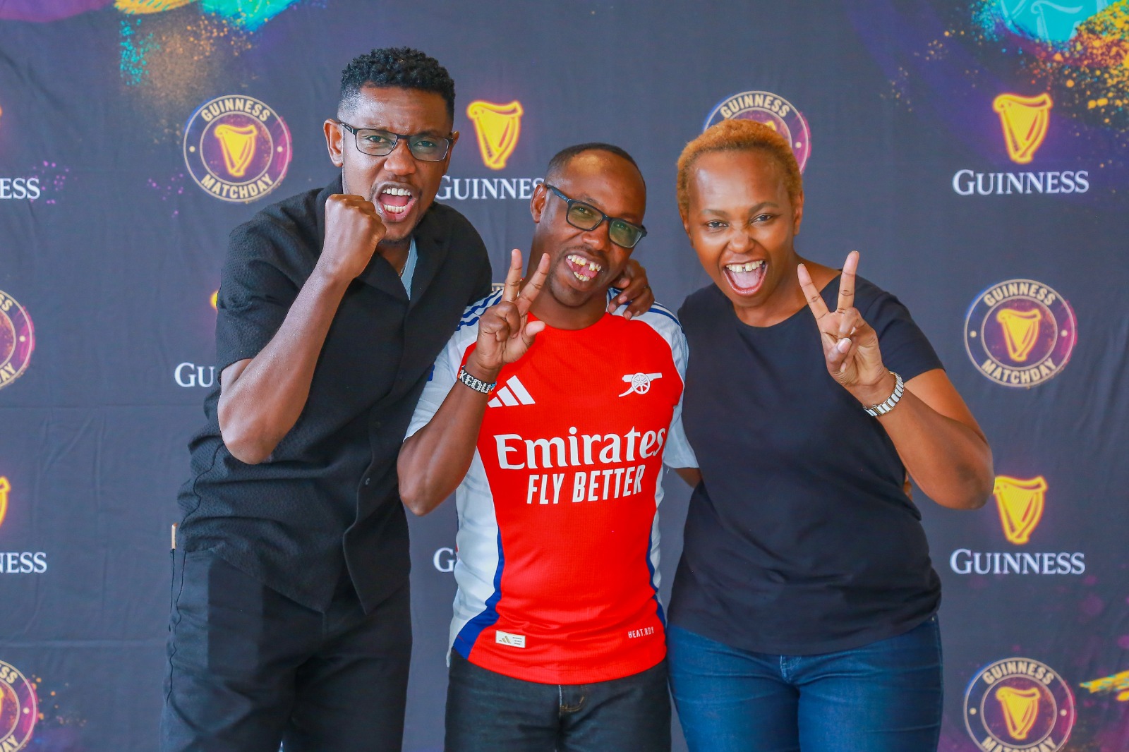 That’s how many goals we’re gonna beat them by – Gunners’ fans Carol Radull (right) and Felix Karbolo (centre) with Man City’s Lotan Salapei during the press announcement of the EPL trip winners held at Eabl Ruaraka offices on Thursday, 19th September.