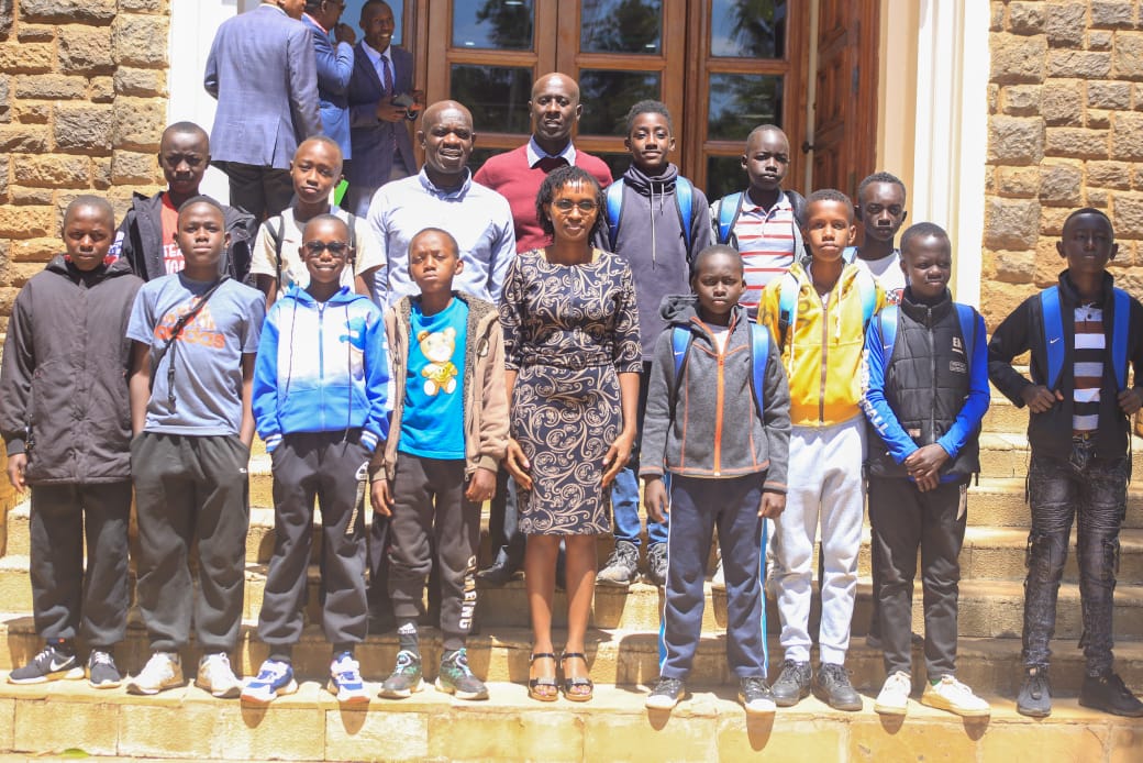 The CECM with other County officials alongside the boys headed to Tanzania 