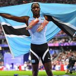 Letsile Tebogo holding Botswana's flag at the Paris 2024 Olympic Games
