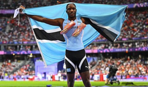 Letsile Tebogo holding Botswana's flag at the Paris 2024 Olympic Games