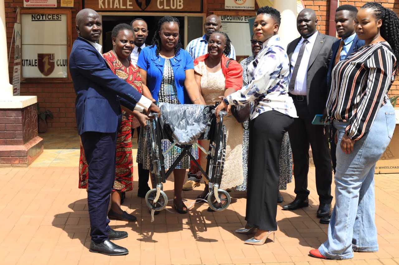 Mary Biketi donating a wheelchair to Trans Nzoia widow's group