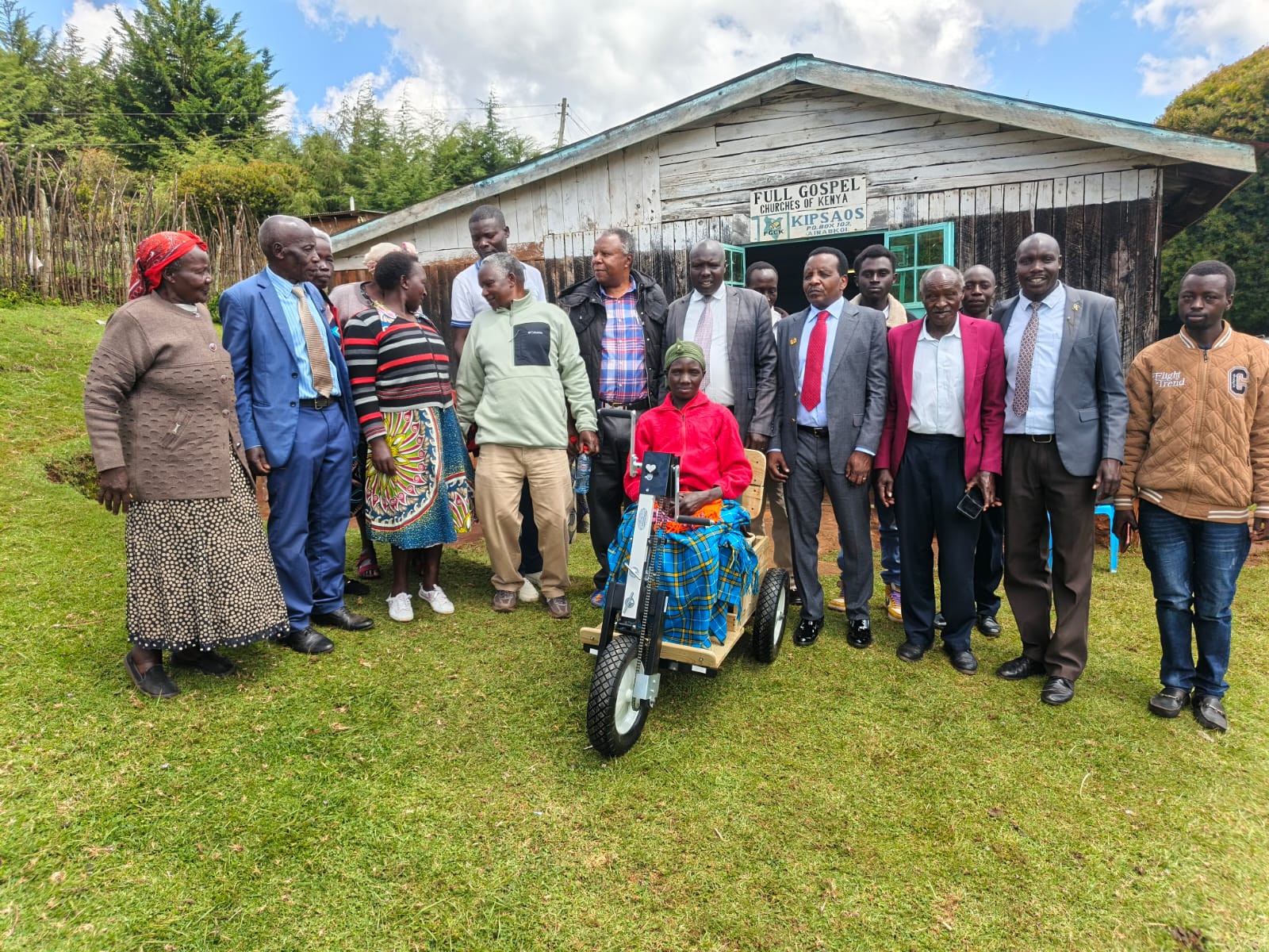 Reuben Kigame with Keiyo South community after donating a wheelchair 