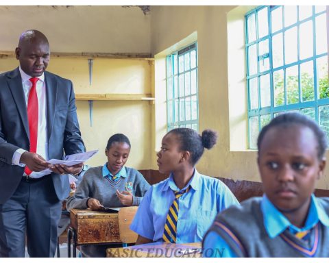 Basic Education PS Prof Julius Bitok distributing KCSE exam papers at Musa Gitau Girls High School