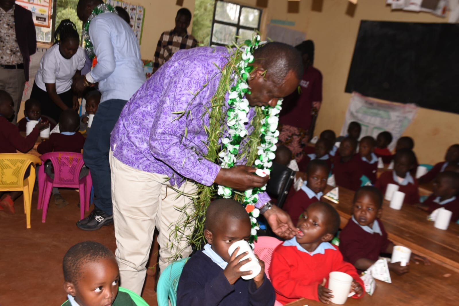 Governor Bii interacts with pupils during launch of a comprehensive child health and nutrition programme at Legetet Primary School