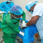 A team of surgeons operating on a patient at Wamalwa Kijana Teaching and Referral Hospital.