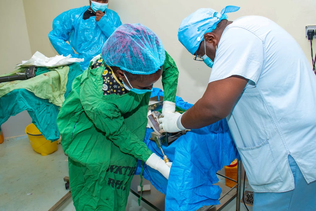 A team of surgeons operating on a patient at Wamalwa Kijana Teaching and Referral Hospital.