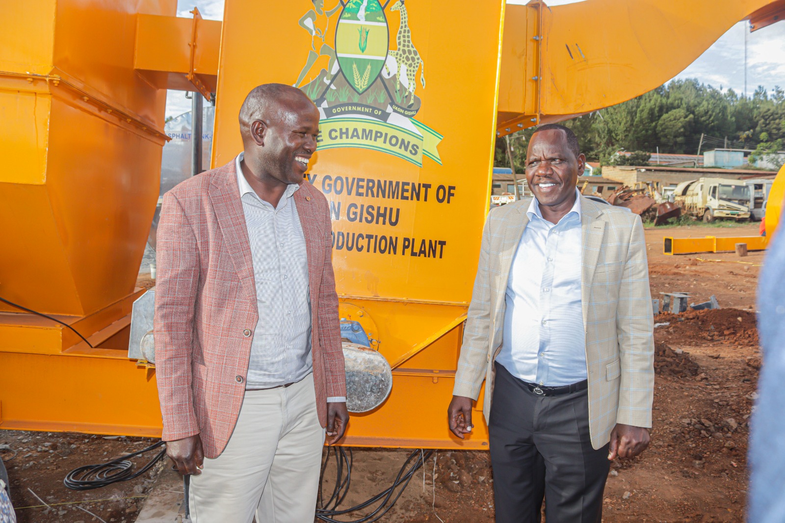 Governor Jonathan Bii with CECM Abraham Serem at county asphalt production plant