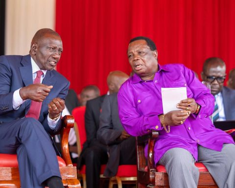 President Ruto chats with COTU secretary general Francis Atwoli during Labour Day celebrations in Vihiga