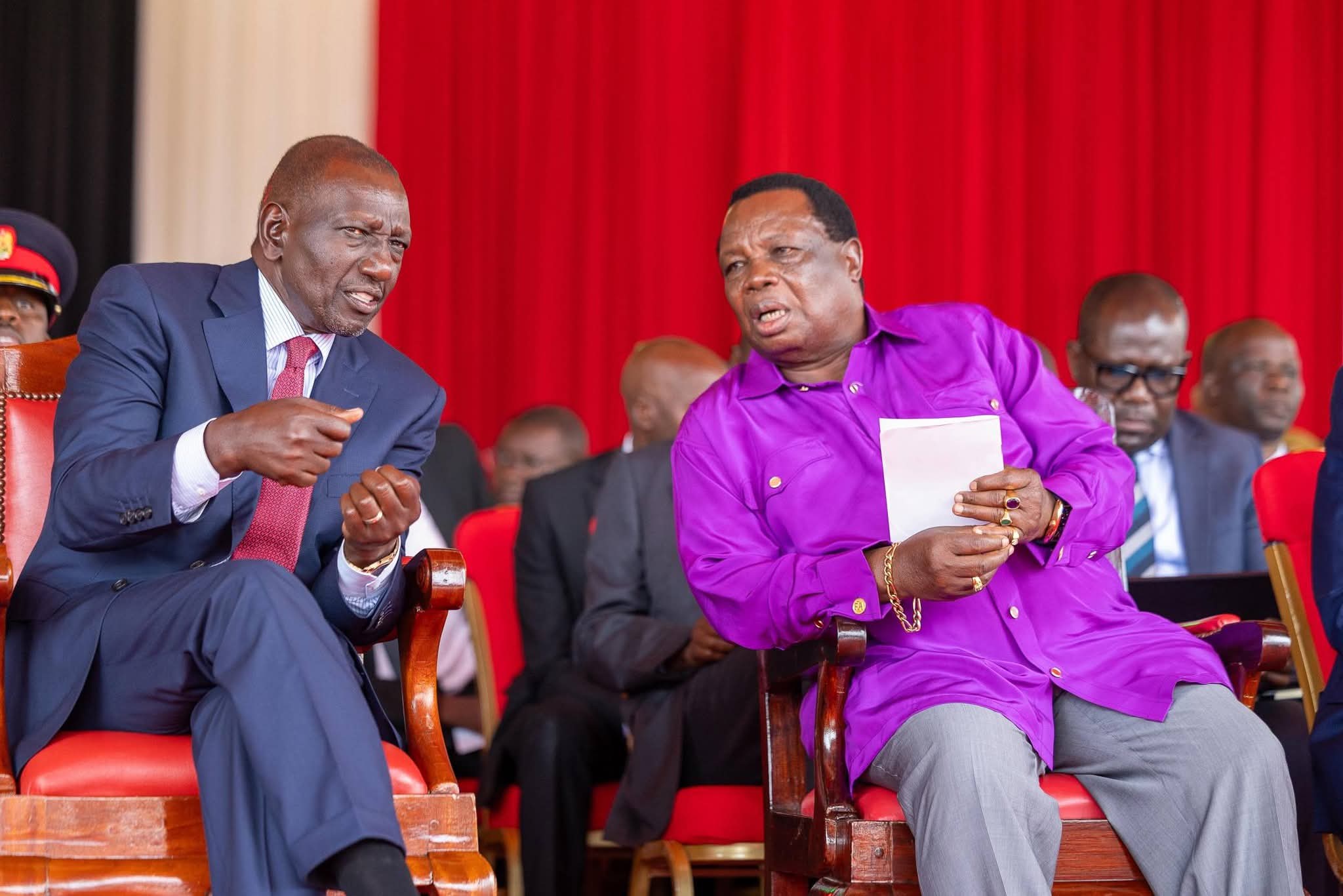 President Ruto chats with COTU secretary general Francis Atwoli during Labour Day celebrations in Vihiga