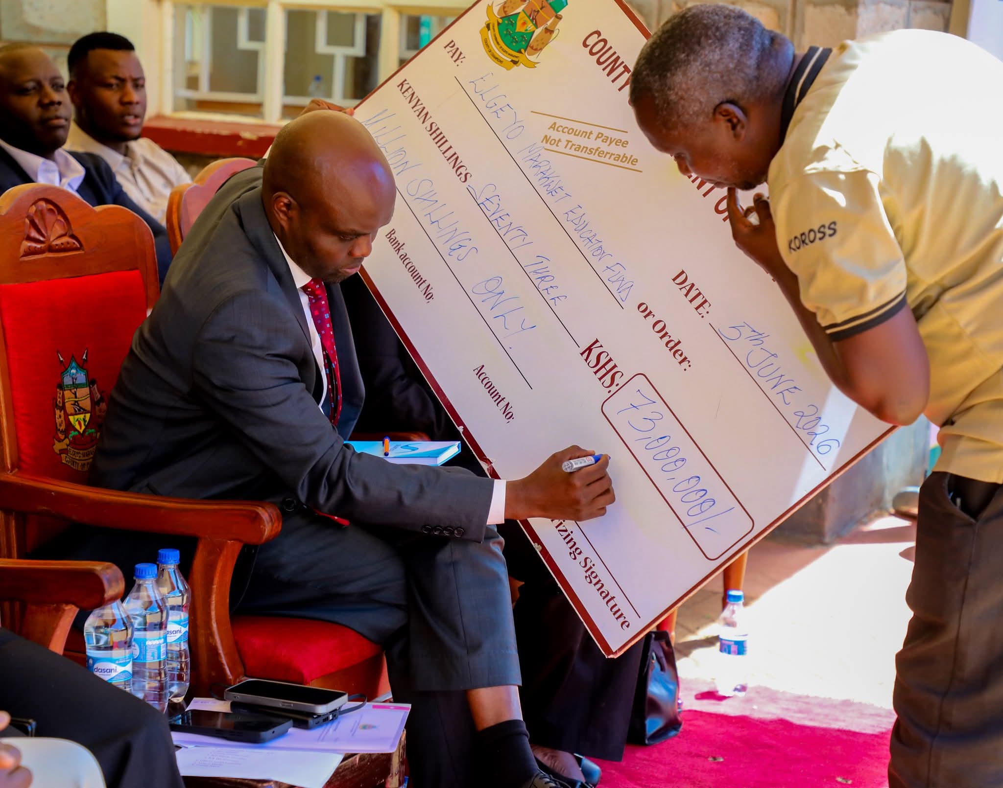 Elgeyo Marakwet Governor Wisley Rotich signs dummy cheque for bursary allocation