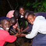 Kipkombot Primary School students drink from a source that feeds River Nzoia,