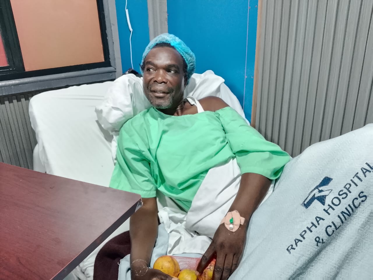 Samuel Akuyi recuperating at Rapha Hospital after a successful surgery to remove a 30kg scrotal mass.
