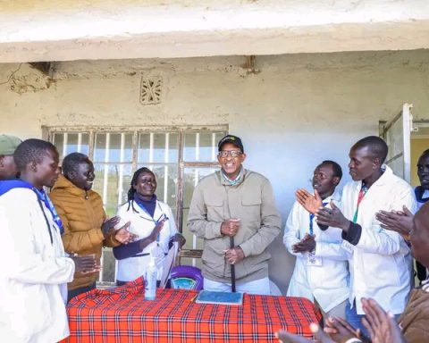 Health CS Aden Duale poses for a photo with staff at Sondany Dispensary in West Pokot County
