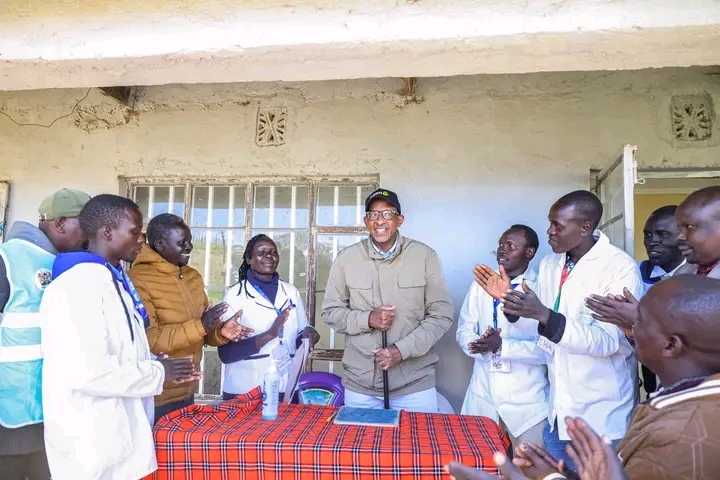 Health CS Aden Duale poses for a photo with staff at Sondany Dispensary in West Pokot County