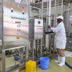 A man operating a milk cooler in Nandi County