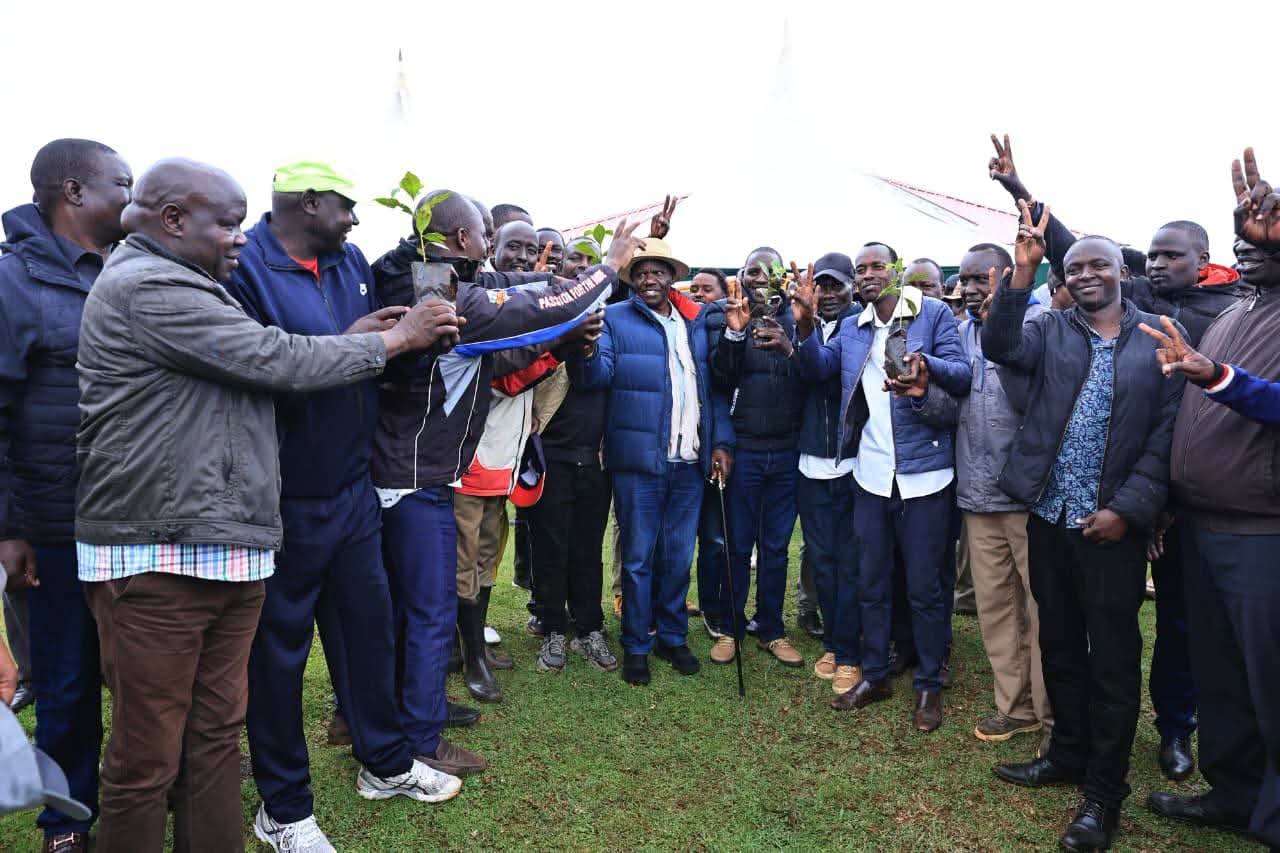 Governor Bii with locals holding coffee seedlings