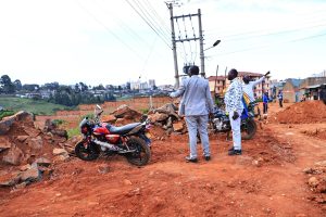 Governor Bii with Roads CEC member Abraham Serem during a visit to Pioneer estate