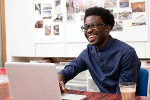 A young man working at his desk in a creative office