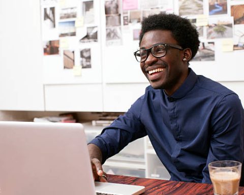 A young man working at his desk in a creative office