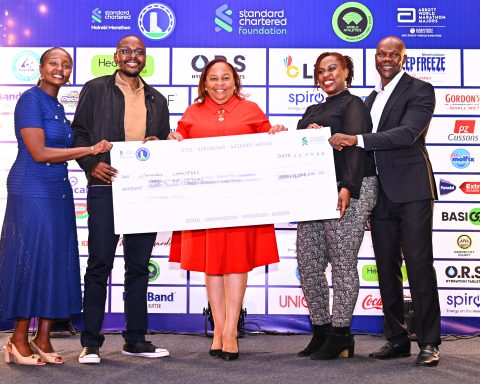 KWAL’s Commercial Director, Alice Mwalimo, leads the team in handing over a Ksh 10 million cheque to Standard Chartered’s Head of Corporate Affairs, Brand & Marketing (CABM) for Kenya & Africa, Joyce Kibe (far left), and Standard Chartered Nairobi Marathon Local Organizing Committee member David Mwindi (far right)