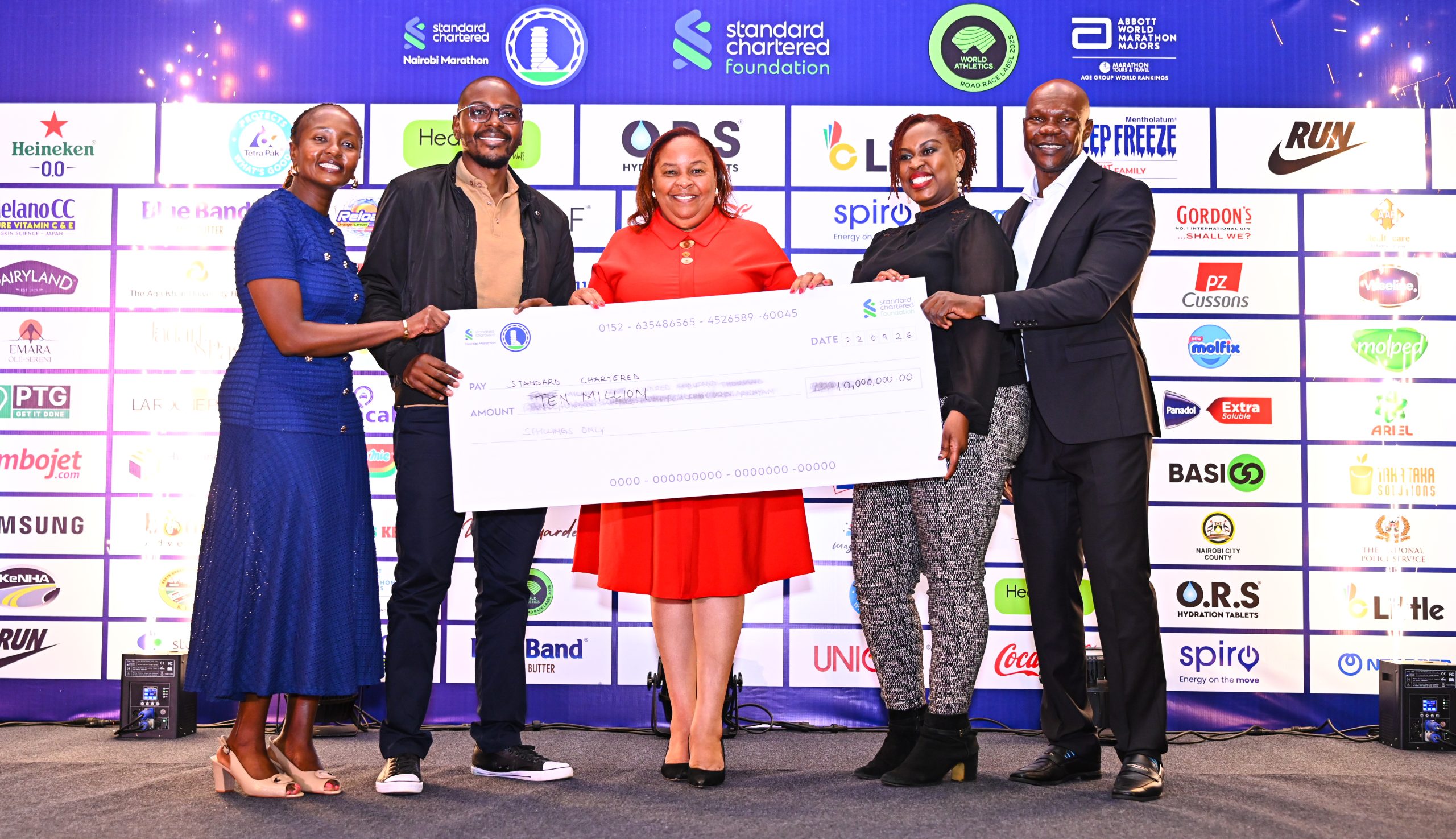KWAL’s Commercial Director, Alice Mwalimo, leads the team in handing over a Ksh 10 million cheque to Standard Chartered’s Head of Corporate Affairs, Brand & Marketing (CABM) for Kenya & Africa, Joyce Kibe (far left), and Standard Chartered Nairobi Marathon Local Organizing Committee member David Mwindi (far right)