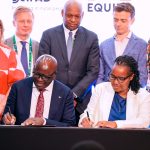 Seated L-R: Equity Bank Kenya Managing Director, Moses Nyabanda, and Gérardine Mukeshimana, IFAD Vice President, during the signing ceremony of the Africa Rural Climate Adaptation Finance Mechanism (ARCAFIM) in Kigali