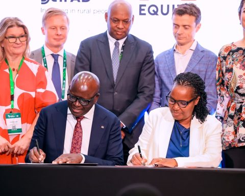 Seated L-R: Equity Bank Kenya Managing Director, Moses Nyabanda, and Gérardine Mukeshimana, IFAD Vice President, during the signing ceremony of the Africa Rural Climate Adaptation Finance Mechanism (ARCAFIM) in Kigali