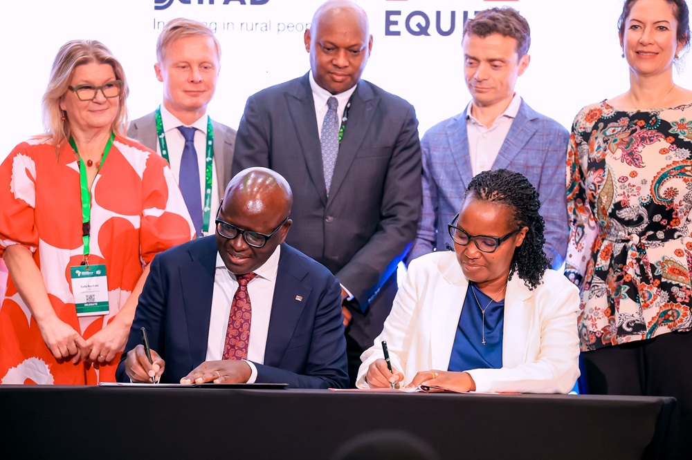 Seated L-R: Equity Bank Kenya Managing Director, Moses Nyabanda, and Gérardine Mukeshimana, IFAD Vice President, during the signing ceremony of the Africa Rural Climate Adaptation Finance Mechanism (ARCAFIM) in Kigali